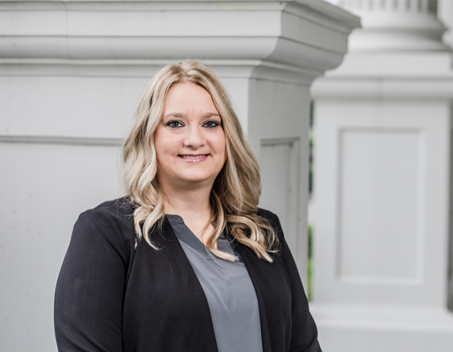 Woman in suit in front of a building