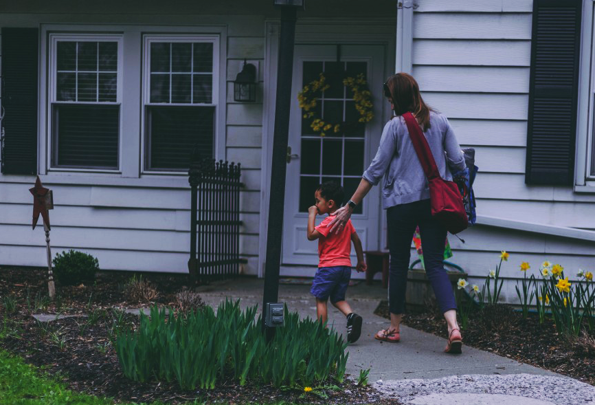 White parent and Black child walking to house
