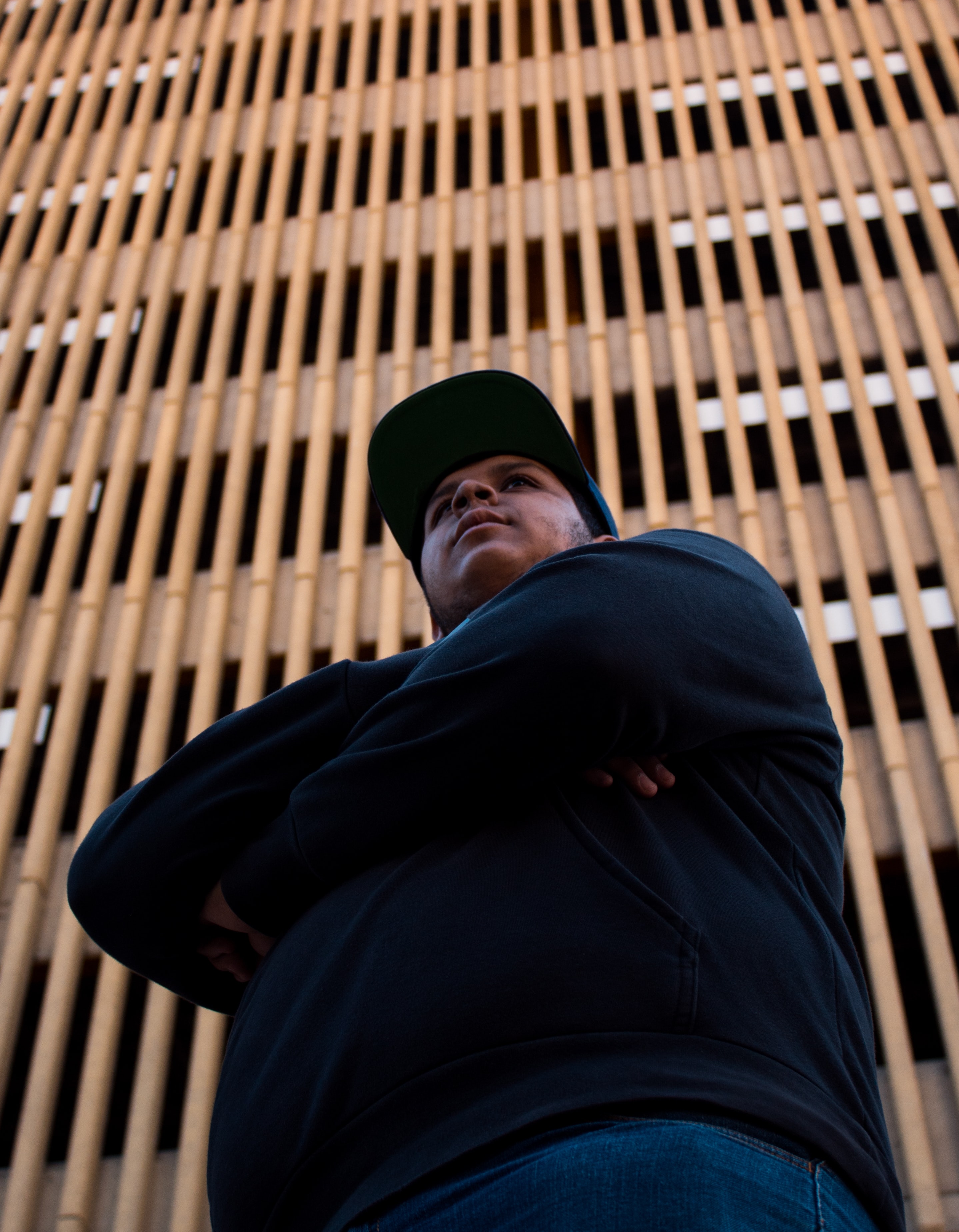 Adult in front of tall building