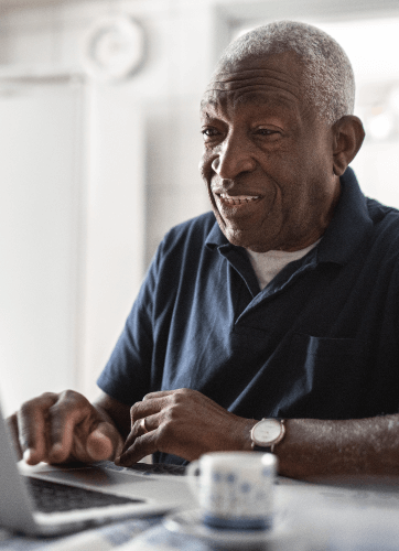 Happy senior man on laptop