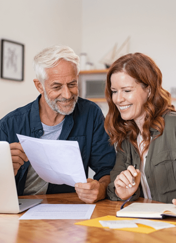 Man and woman looking at a document together and smiling