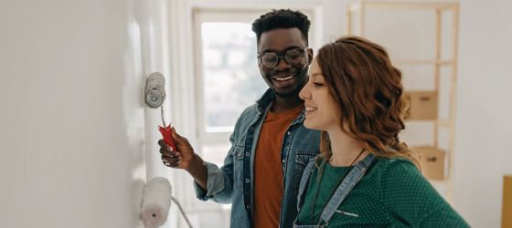 Couple painting the wall together