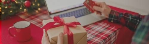 Person holding holiday package and credit card