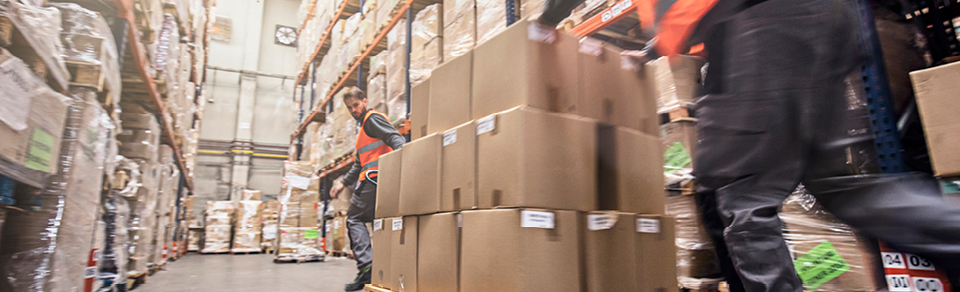 Warehouse workers moving boxes