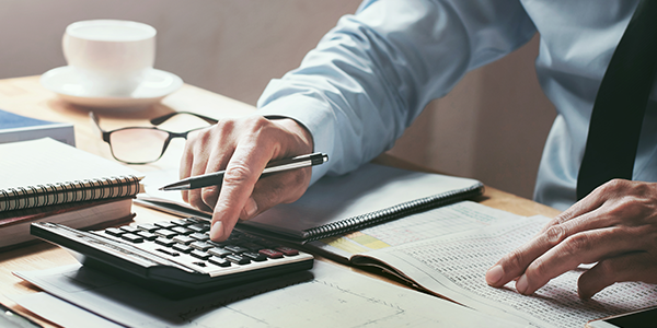 Person using a calculator for financial planning