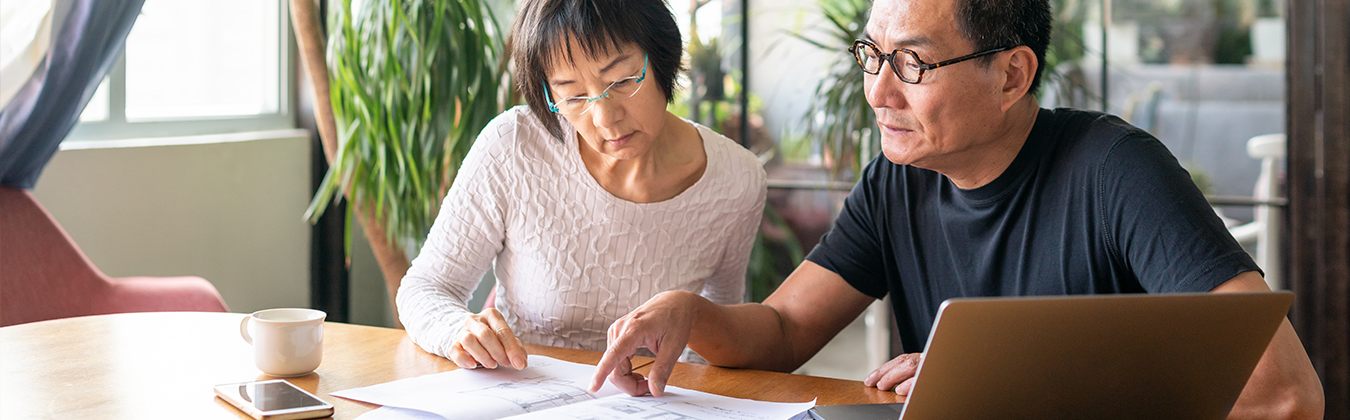Two people reading a pamphlet together
