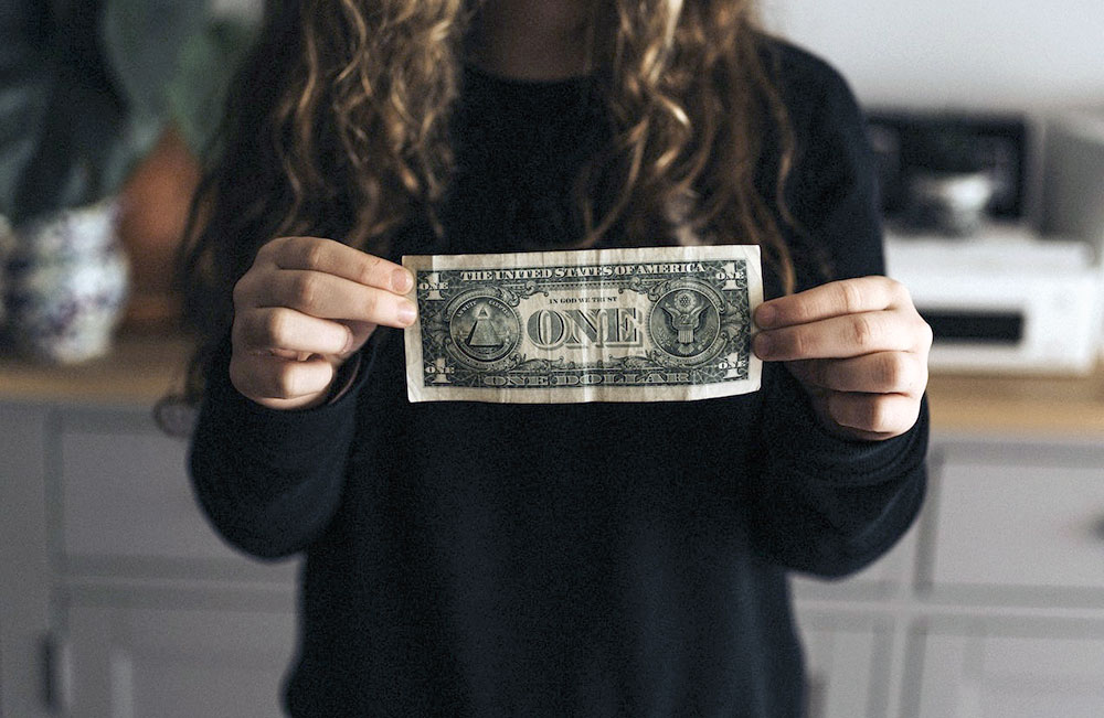 Woman holding a dollar in two hands