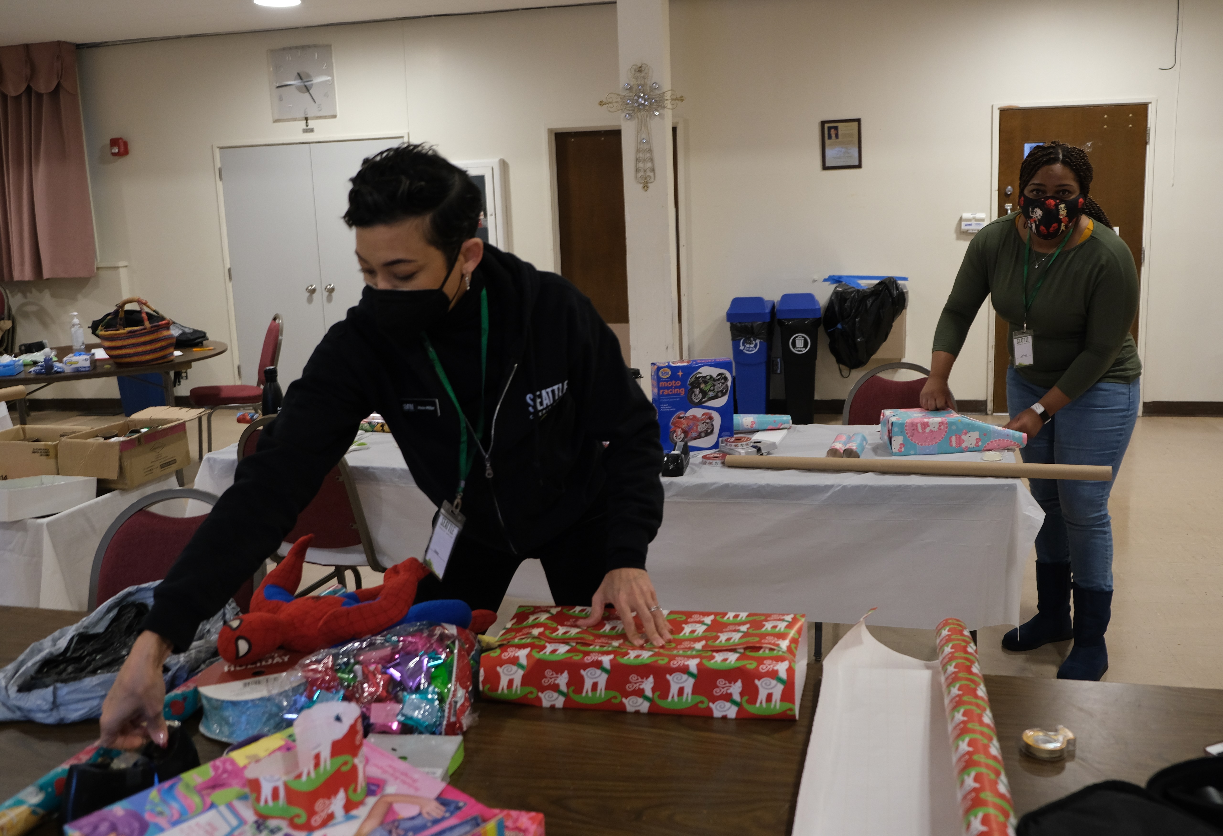 Volunteer from Seattle Credit Union wrapping holiday presents