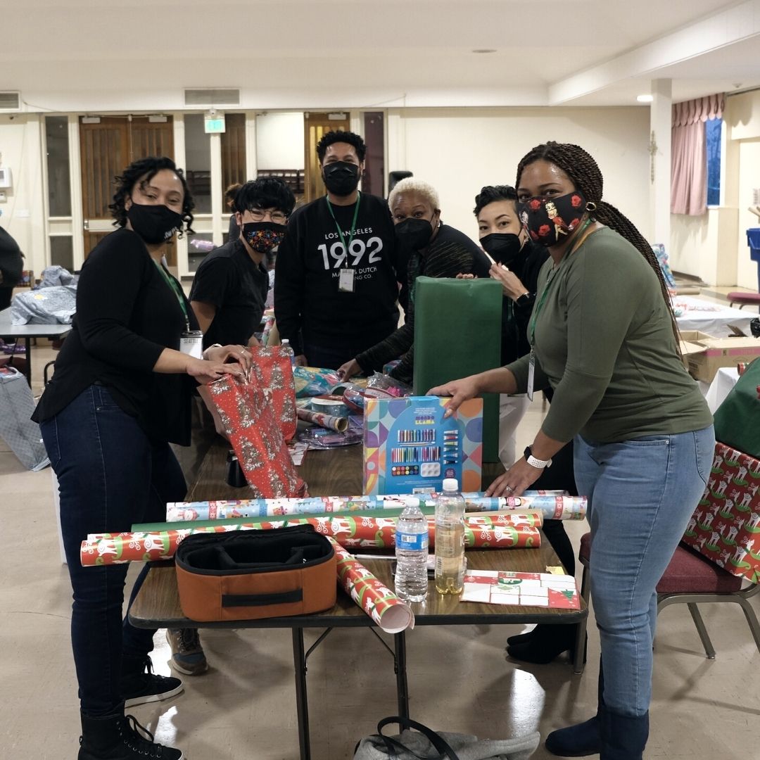 Volunteers gathering to wrap holiday presents
