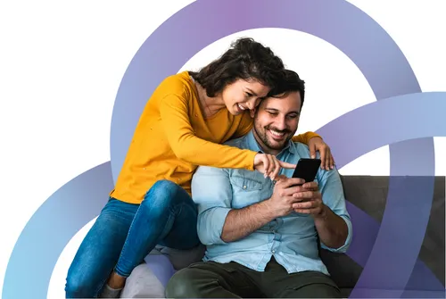 Couple on couch looking at phone together