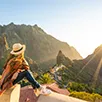 Woman Looking at Sunset over mountains